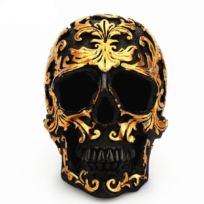 Goldene Schnitzerei, schwarze Totenkopf-Skulptur